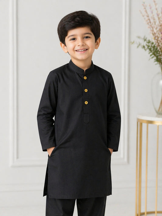 Young boy wearing a black Shalwar Kameez with yellow buttons